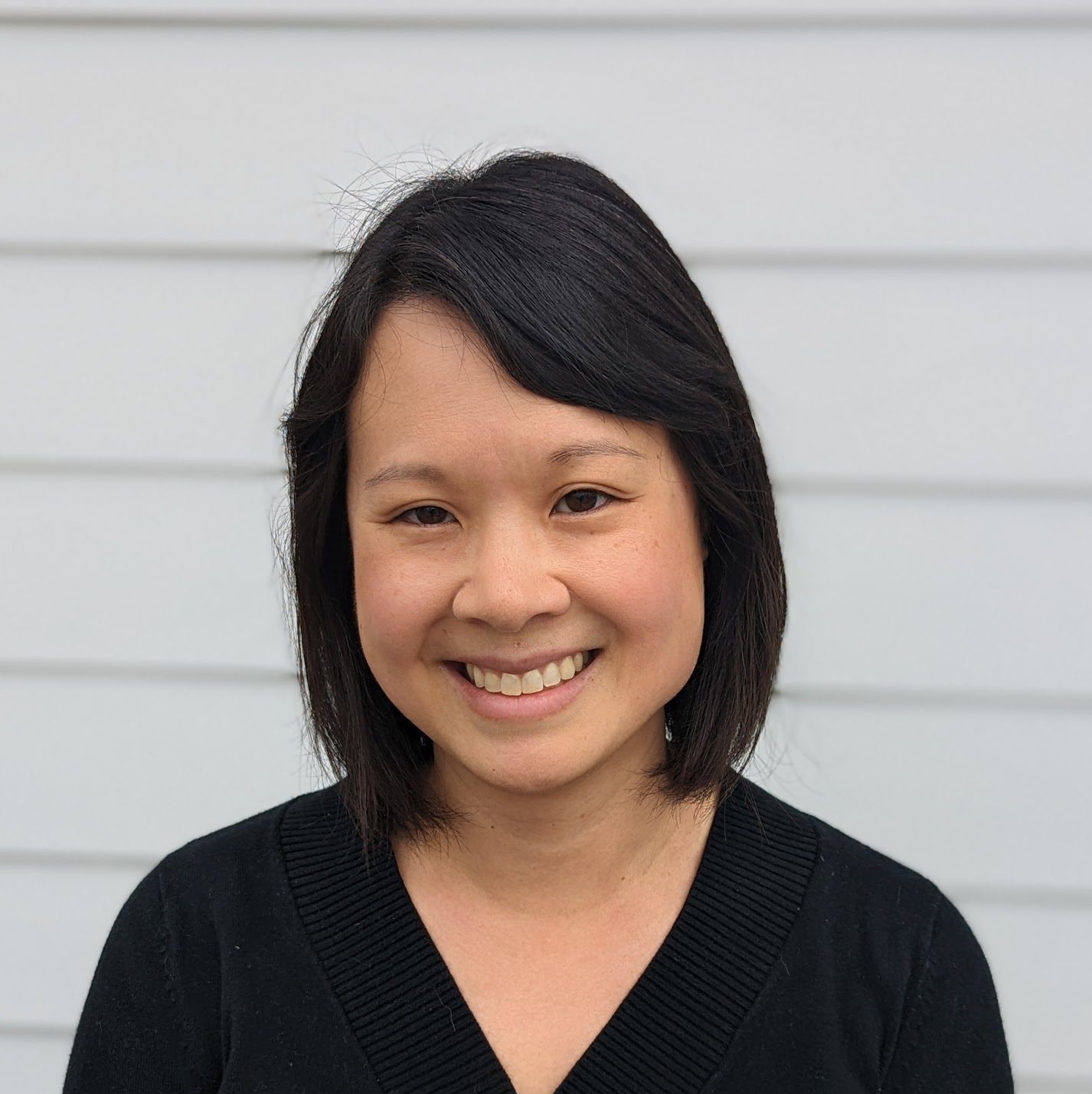Smiling headshot of Naishin - young, Asian woman with short hair
