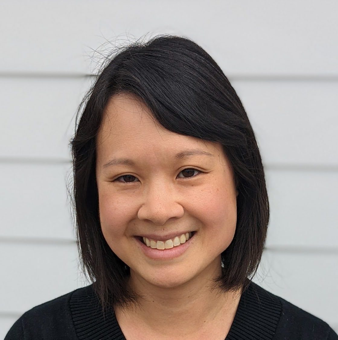 Smiling headshot of Naishin - young, Asian woman with short hair