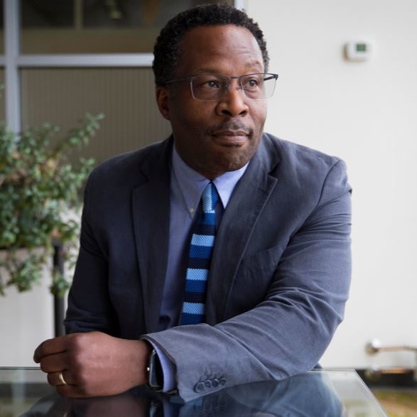 Headshot of Stephan - Black man with glasses and suit